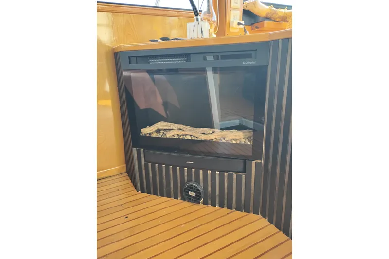 Slide: The Image of Electric fireplace on 1988 PT 52 AFT Cabin Motor Yacht with wood paneling. - 41