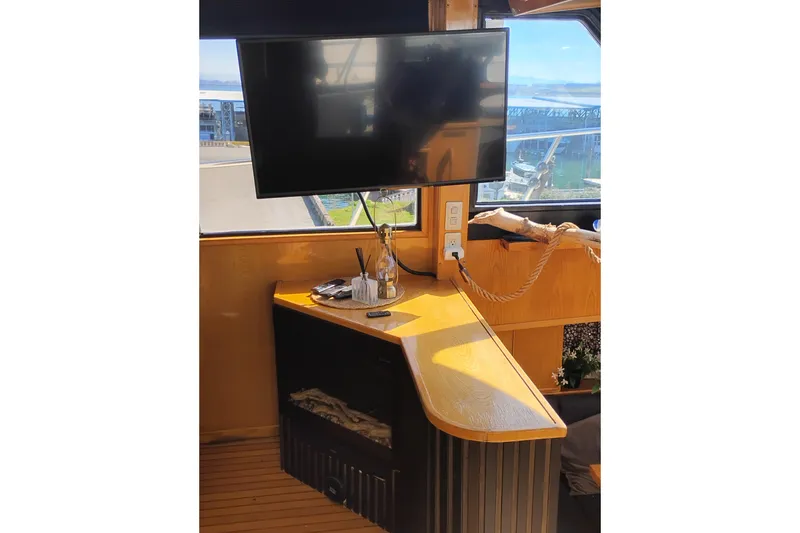 Slide: The Image of Interior of 1988 PT 52 AFT Cabin Motor Yacht with TV and wooden counter. - 42