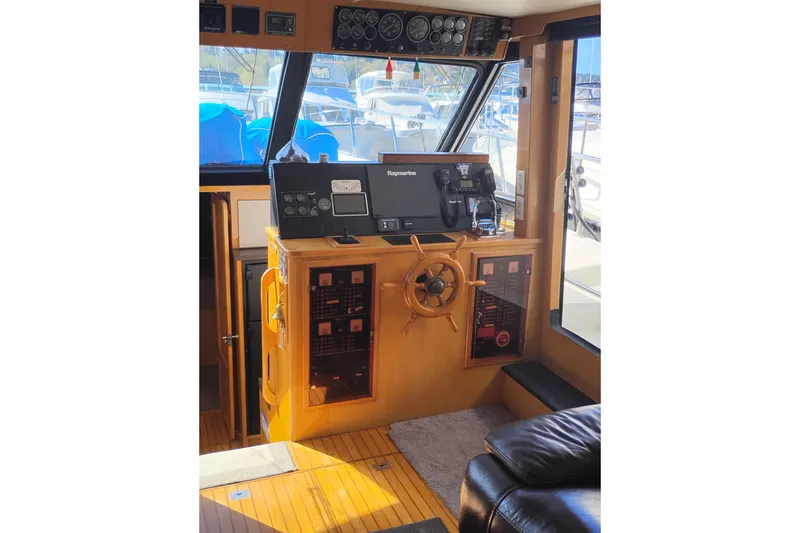 Slide: The Image of 1988 PT 52 AFT Cabin Motor Yacht helm with navigation equipment and wooden steering wheel. - 43