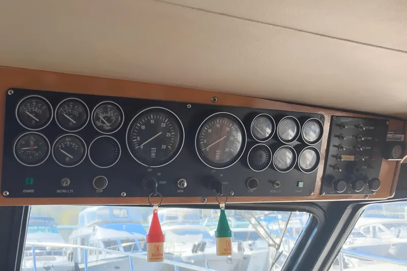 Slide: The Image of Control panel of a 1988 PT 52 AFT Cabin Motor Yacht with gauges and switches. - 50