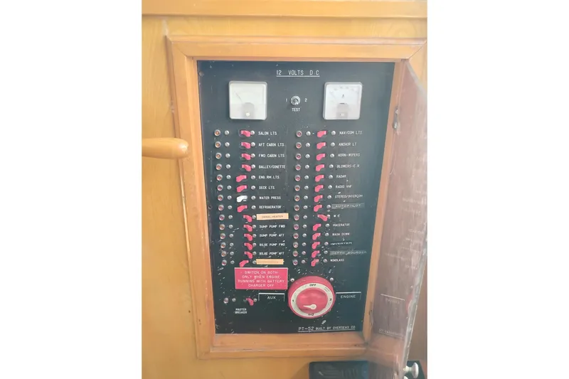 Slide: The Image of Electrical panel of a 1988 PT 52 AFT Cabin Motor Yacht with labeled switches. - 53