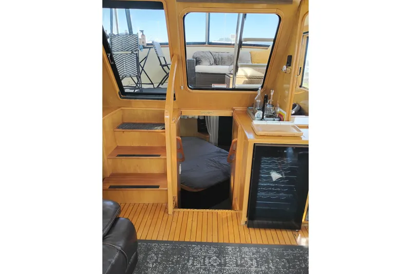 Slide: The Image of Interior of 1988 PT 52 AFT Cabin Motor Yacht with stairs, seating, and mini bar. - 55
