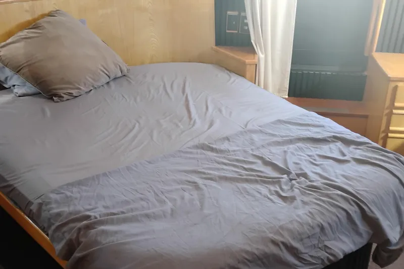 Slide: The Image of Cozy cabin bedroom in 1988 PT 52 AFT Motor Yacht with gray bedding. - 56