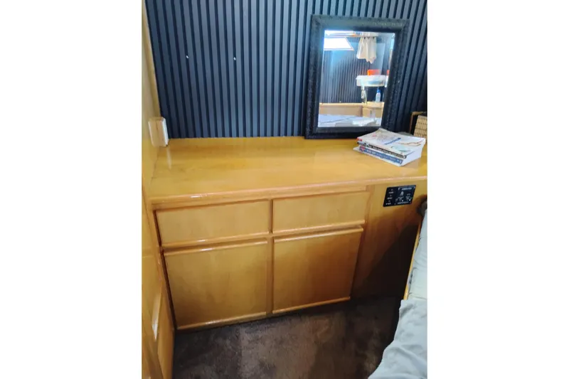 Slide: The Image of 1988 PT 52 AFT Cabin Motor Yacht interior with wooden cabinet and mirror. - 57
