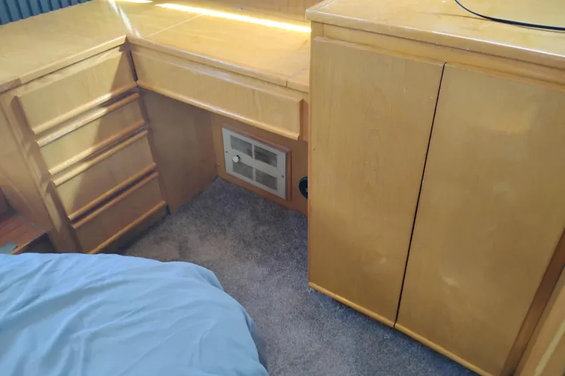 Slide: The Image of Interior of 1988 PT 52 AFT Cabin Motor Yacht with wooden cabinetry and carpeted floor. - 62