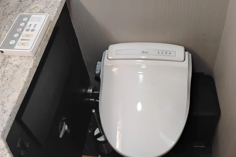 Slide: The Image of Luxury yacht bathroom with modern bidet toilet and control panel, PT 52 AFT Cabin Motor Yacht, 1988. - 67