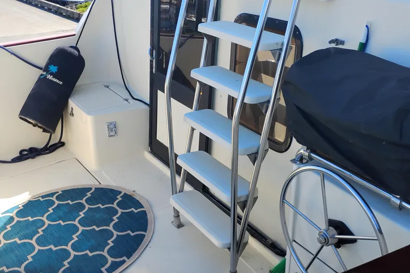 Slide: The Image of 1988 PT 52 AFT Cabin Motor Yacht interior with ladder, wheel, and blue rug. - 7