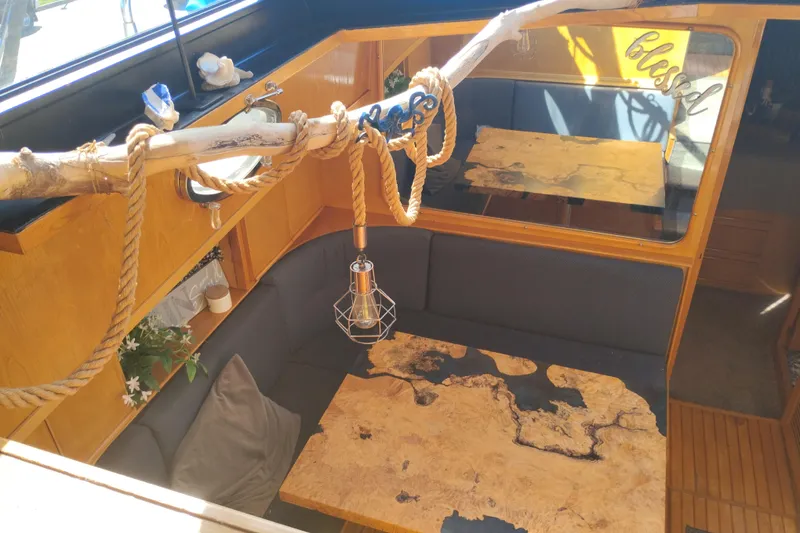 Slide: The Image of Interior of 1988 PT 52 AFT Cabin Motor Yacht with rustic decor and unique wooden table. - 73