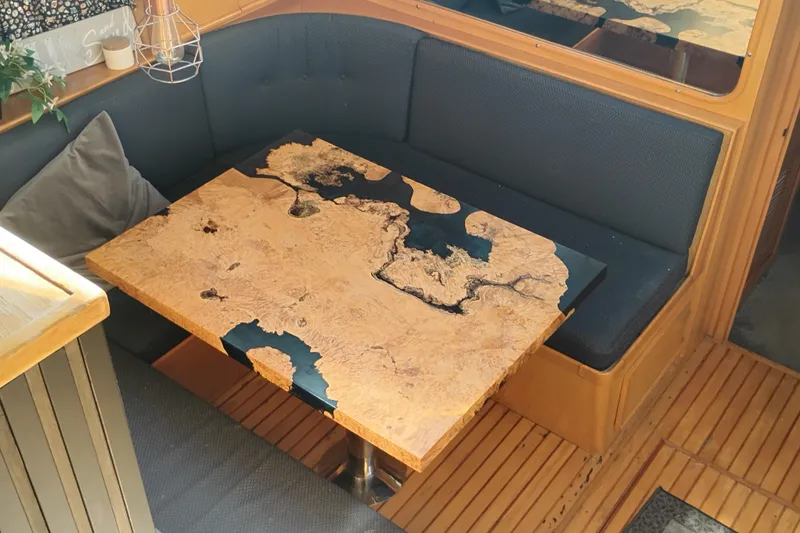 Slide: The Image of 1988 PT 52 AFT Cabin Motor Yacht interior with unique wooden table design. - 74