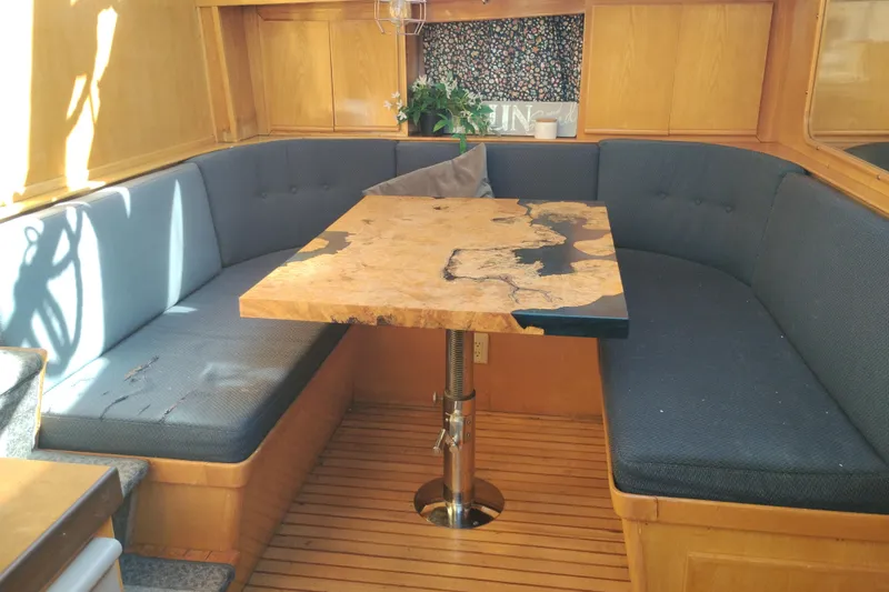 Slide: The Image of Luxurious 1988 PT 52 AFT Cabin Motor Yacht interior with custom wood table and cozy seating. - 76
