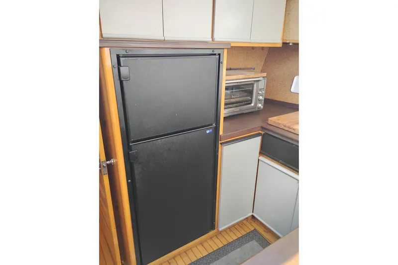 Slide: The Image of 1988 PT 52 AFT Cabin Motor Yacht kitchen with fridge and toaster oven. - 79