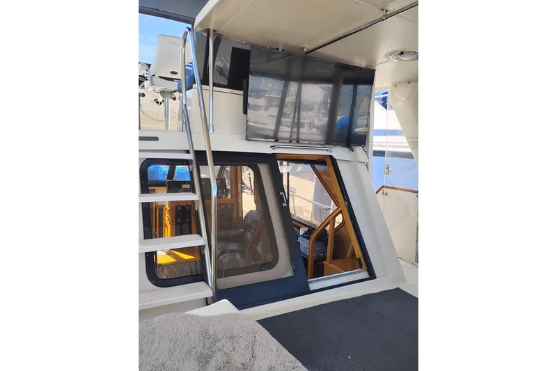 Slide: The Image of 1988 PT 52 AFT Cabin Motor Yacht interior with ladder and seating area. - 8