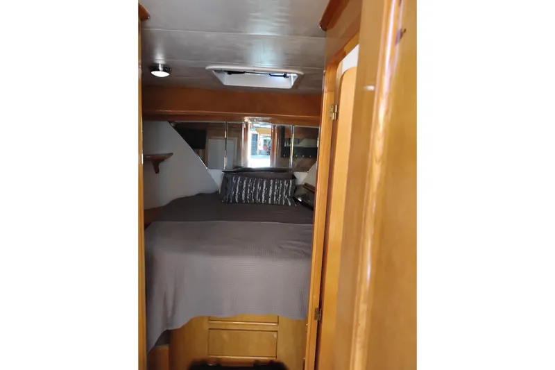 Slide: The Image of Cozy cabin interior of 1988 PT 52 AFT Motor Yacht with bed and wooden finish. - 86