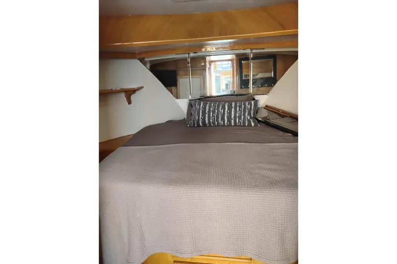 Slide: The Image of Cozy cabin interior of 1988 PT 52 AFT Motor Yacht with elegant bedding and wood accents. - 87