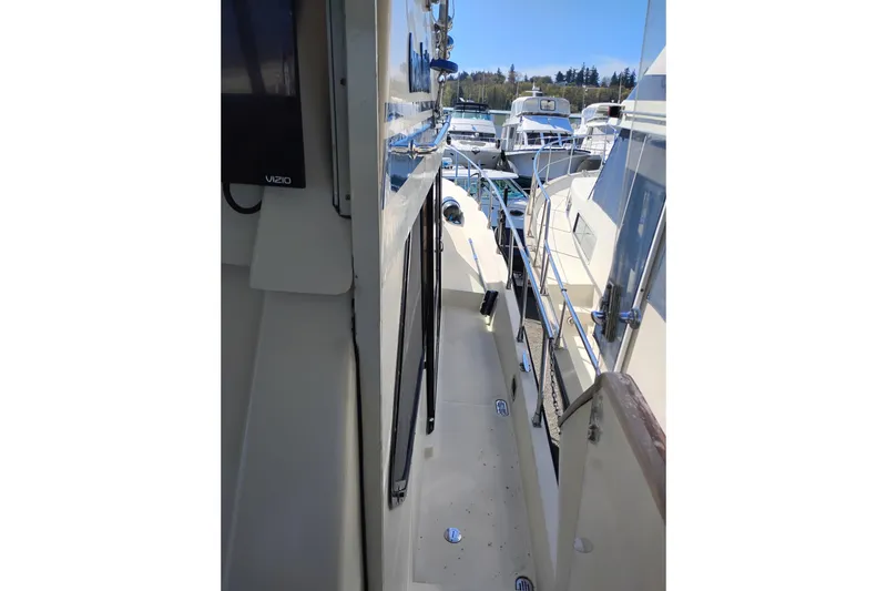 Slide: The Image of 1988 PT 52 AFT Cabin Motor Yacht docked, showing side deck and railing. - 97