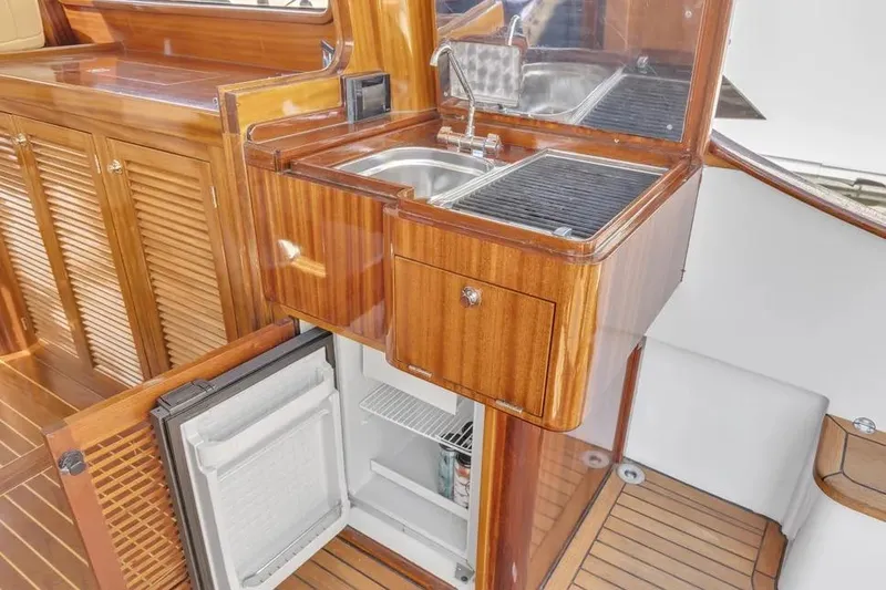 Slide: The Image of Luxurious wooden kitchenette on 2007 Gorbon Custom Downeast 40 yacht with sink and fridge. - 13