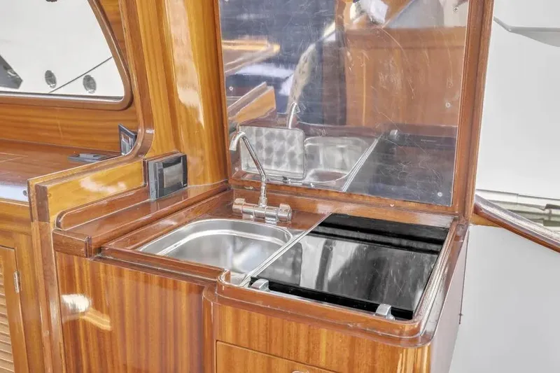 Slide: The Image of Wooden kitchen area on 2007 Gorbon Custom Downeast 40 yacht with sink and stove. - 14