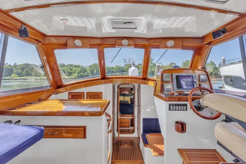 Slide: The Image of Interior of 2007 Gorbon Custom Downeast 40 yacht with wooden accents and navigation equipment. - 19