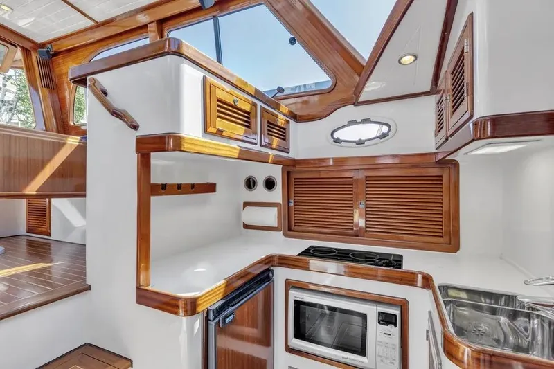 Slide: The Image of Luxurious 2007 Gorbon Custom Downeast 40 yacht interior with modern kitchen amenities. - 24