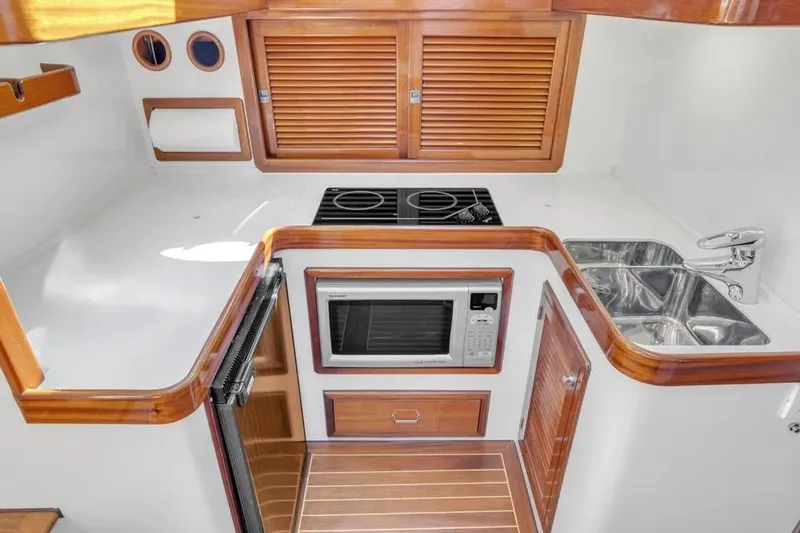 Slide: The Image of Compact kitchen in 2007 Gorbon Custom Downeast 40 yacht with stove, microwave, and sink. - 26
