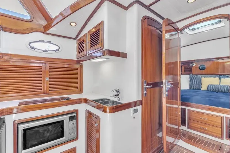 Slide: The Image of Interior of 2007 Gorbon Custom Downeast 40 yacht with wood finishes and modern amenities. - 27