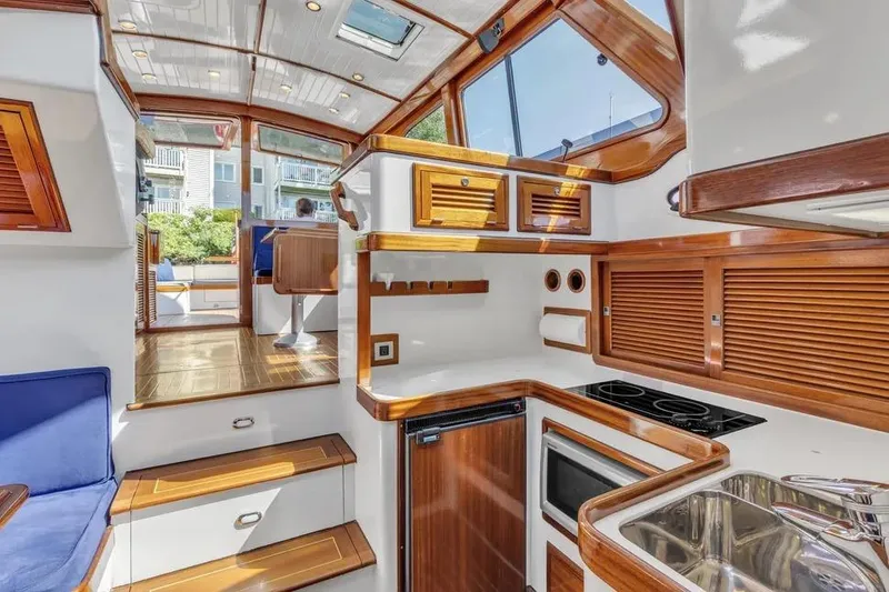 Slide: The Image of Luxurious interior of 2007 Gorbon Custom Downeast 40 yacht with wood accents and modern amenities. - 32