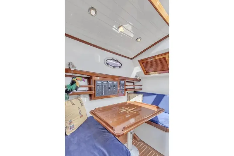 Slide: The Image of Interior of 2007 Gorbon Custom Downeast 40 yacht with wooden table and blue seating. - 33