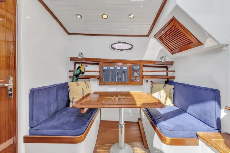 Slide: The Image of Interior of 2007 Gorbon Custom Downeast 40 yacht with blue seating and wooden table. - 34