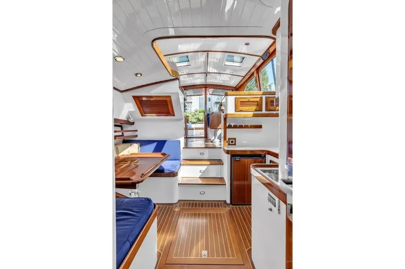 Slide: The Image of Luxurious interior of 2007 Gorbon Custom Downeast 40 yacht with wood accents and blue seating. - 38