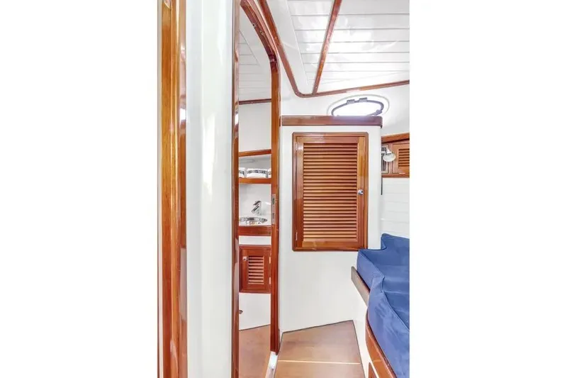 Slide: The Image of Interior of 2007 Gorbon Custom Downeast 40 yacht with wooden finishes and blue seating. - 39