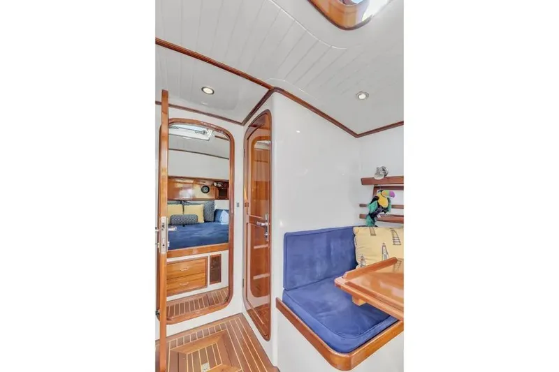 Slide: The Image of Interior of 2007 Gorbon Custom Downeast 40 yacht with wood finish and blue seating. - 40