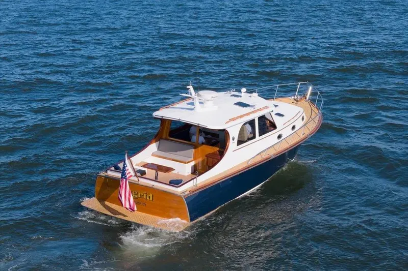 Slide: The Image of 2007 Gorbon Custom Downeast 40 yacht cruising on open water, rear view. - 5