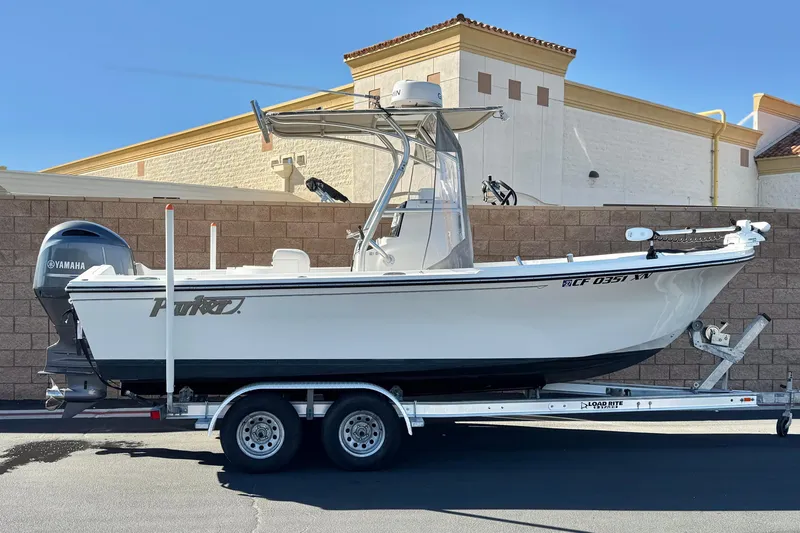 The Image of 2023 Parker 21SE Center Console boat on trailer, featuring Yamaha outboard motor. - 0