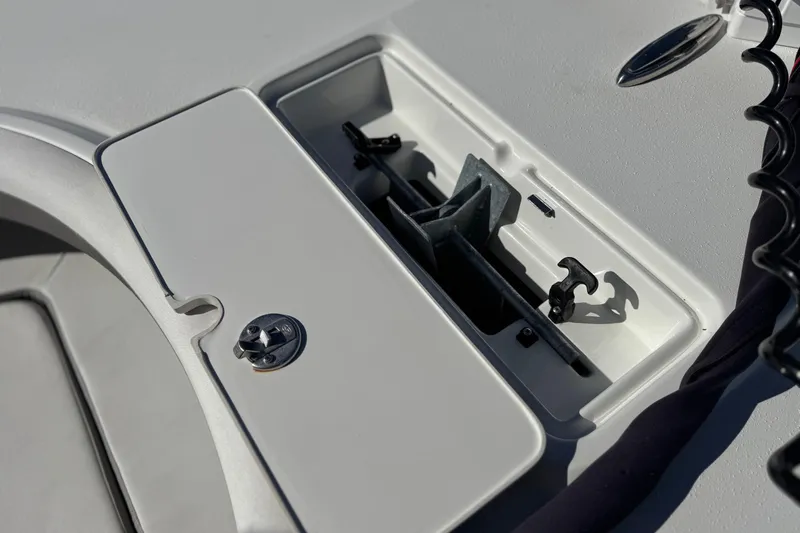 Slide: The Image of 2023 Parker 21SE Center Console boat anchor storage compartment, featuring secure latch and organized layout. - 14