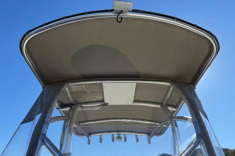 Slide: The Image of 2023 Parker 21SE Center Console boat canopy against clear blue sky. - 19