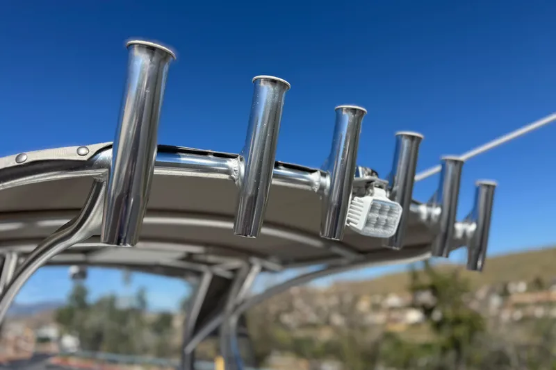 Slide: The Image of Stainless steel rod holders on 2023 Parker 21SE Center Console boat against clear blue sky. - 20