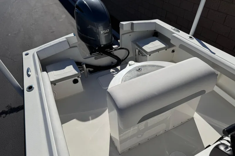 Slide: The Image of 2023 Parker 21SE Center Console boat interior with seating and outboard motor. - 22
