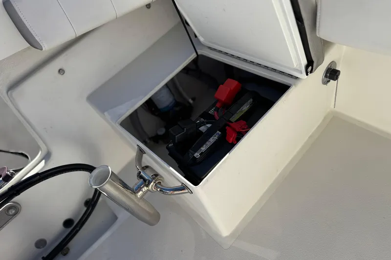Slide: The Image of 2023 Parker 21SE Center Console boat battery compartment with open hatch and visible wiring. - 25