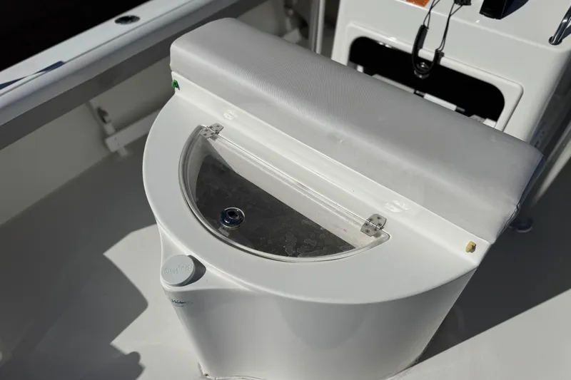 Slide: The Image of 2023 Parker 21SE Center Console boat with cushioned seating and storage compartment. - 26