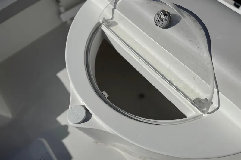 Slide: The Image of Open hatch on 2023 Parker 21SE Center Console boat, showcasing storage compartment. - 27