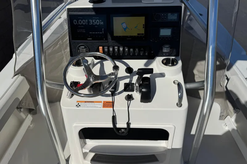 Slide: The Image of 2023 Parker 21SE Center Console boat dashboard with steering wheel and navigation controls. - 29