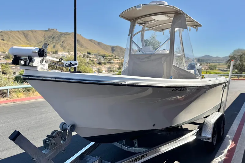 Slide: The Image of 2023 Parker 21SE Center Console boat on trailer, scenic mountain backdrop. - 3