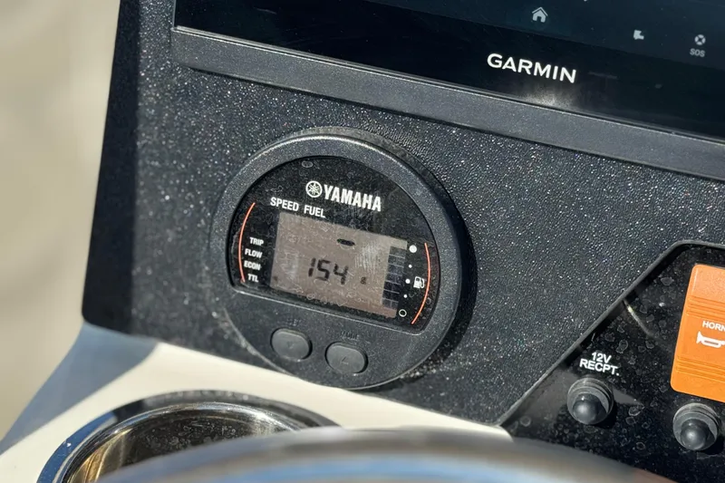 Slide: The Image of Yamaha speed fuel gauge on 2023 Parker 21SE Center Console boat dashboard with Garmin display. - 34