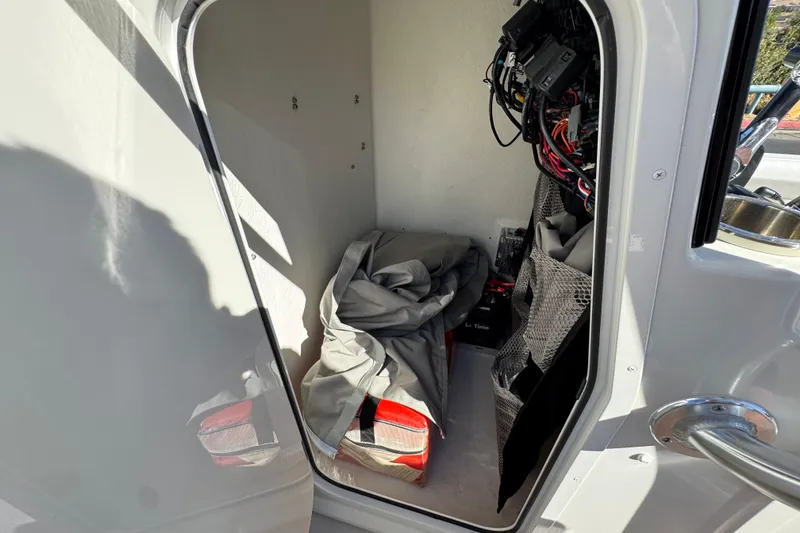 Slide: The Image of Storage compartment of 2023 Parker 21SE Center Console boat with equipment and wiring. - 36
