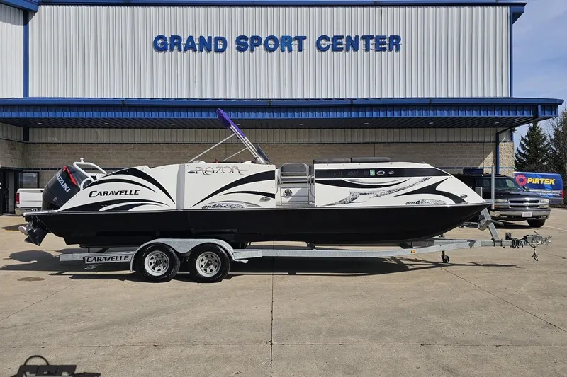The Image of 2014 Caravelle 247 UU Razor E-Toon boat on trailer at Grand Sport Center. - 1