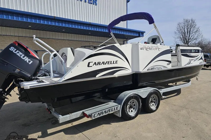 Slide: The Image of 2014 Caravelle 247 UU Razor E-Toon boat on trailer with Suzuki outboard motor. - 12