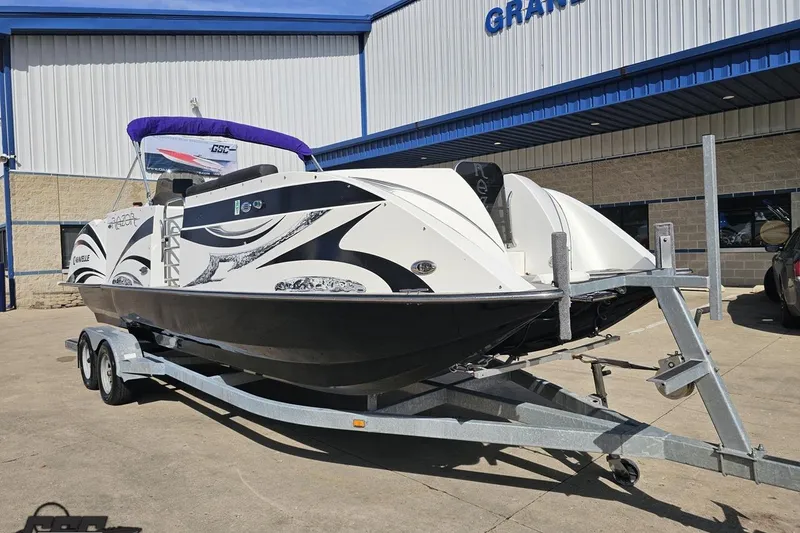 Slide: The Image of 2014 Caravelle 247 UU Razor E-Toon boat on trailer outside dealership. - 18
