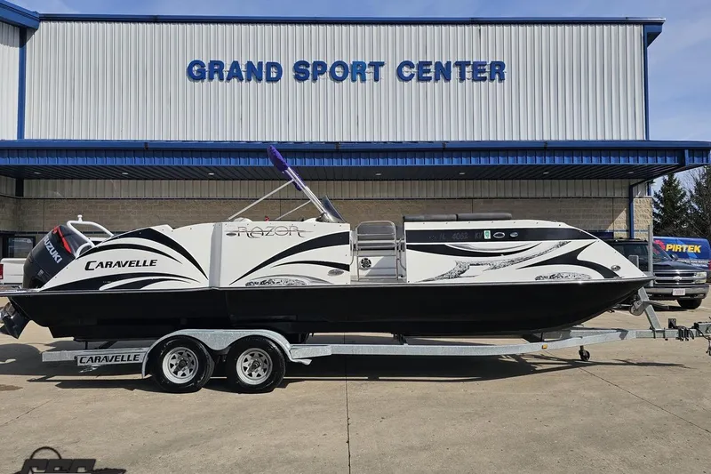 Slide: The Image of 2014 Caravelle 247 UU Razor E-Toon boat on trailer at Grand Sport Center. - 2