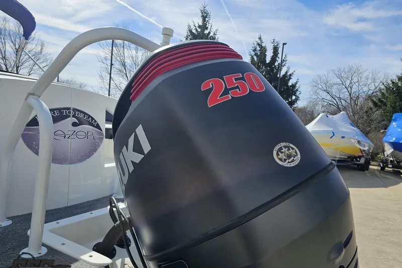 Slide: The Image of Outboard motor on a 2014 Caravelle 247 UU Razor E-Toon boat, parked outdoors. - 35