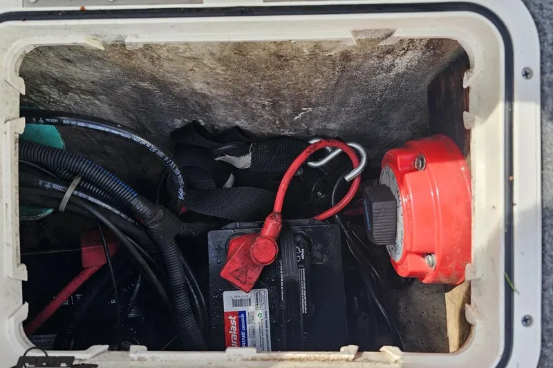 Slide: The Image of Battery compartment of a 2014 Caravelle 247 UU Razor E-Toon with wiring and red switch. - 39